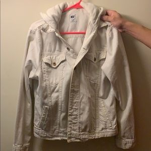 A distressed jean jacket with 100% cotton hood.